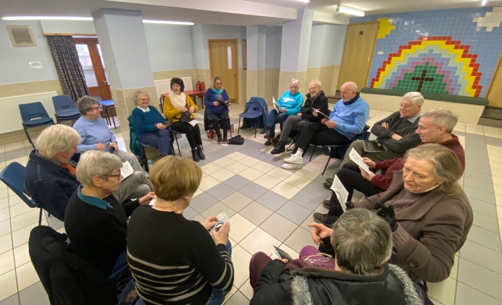 Group of people sat in circle reading a script