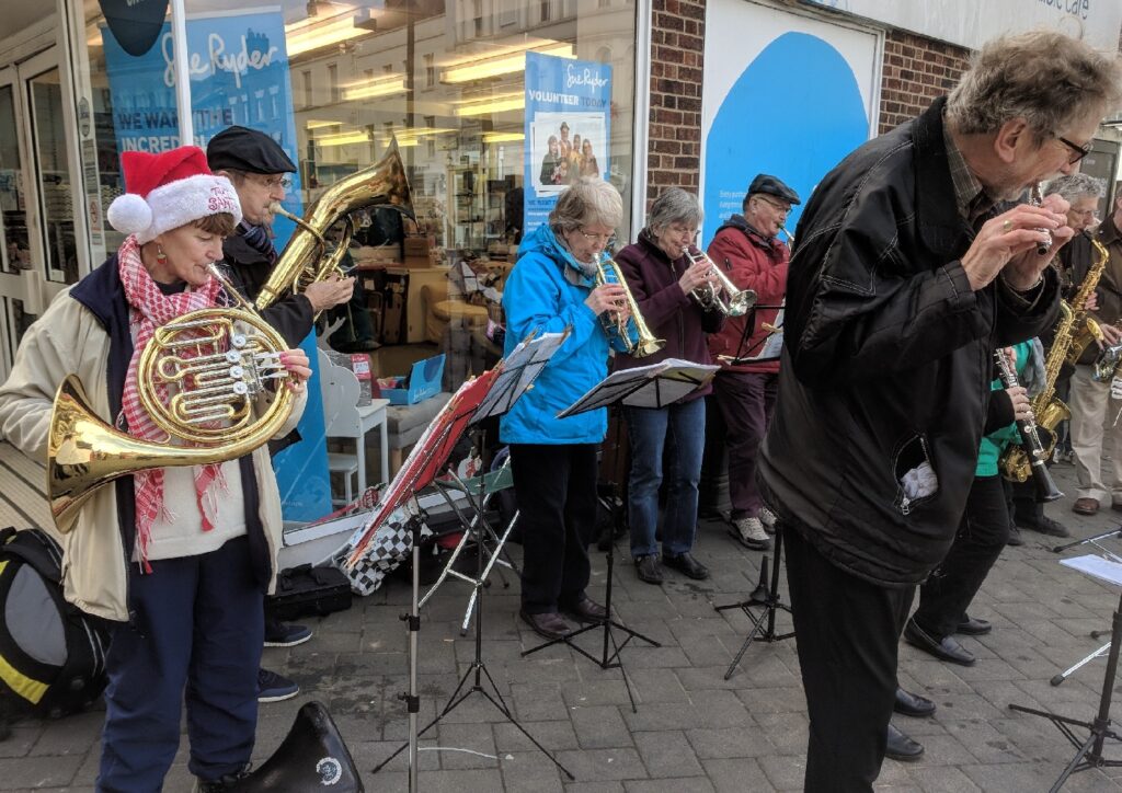 Members of the concert band playing on the High Street Evesham.