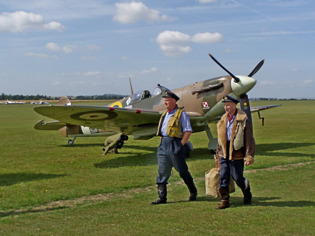 Pilots walking in front of a WW2 aircraft