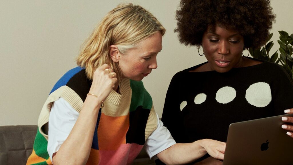 Two woman look at an iPad